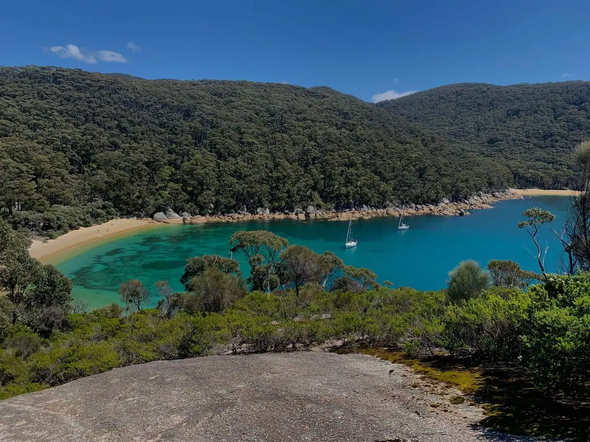 A sheltered turquoise cove fringed by forest at Wilsons Promontory